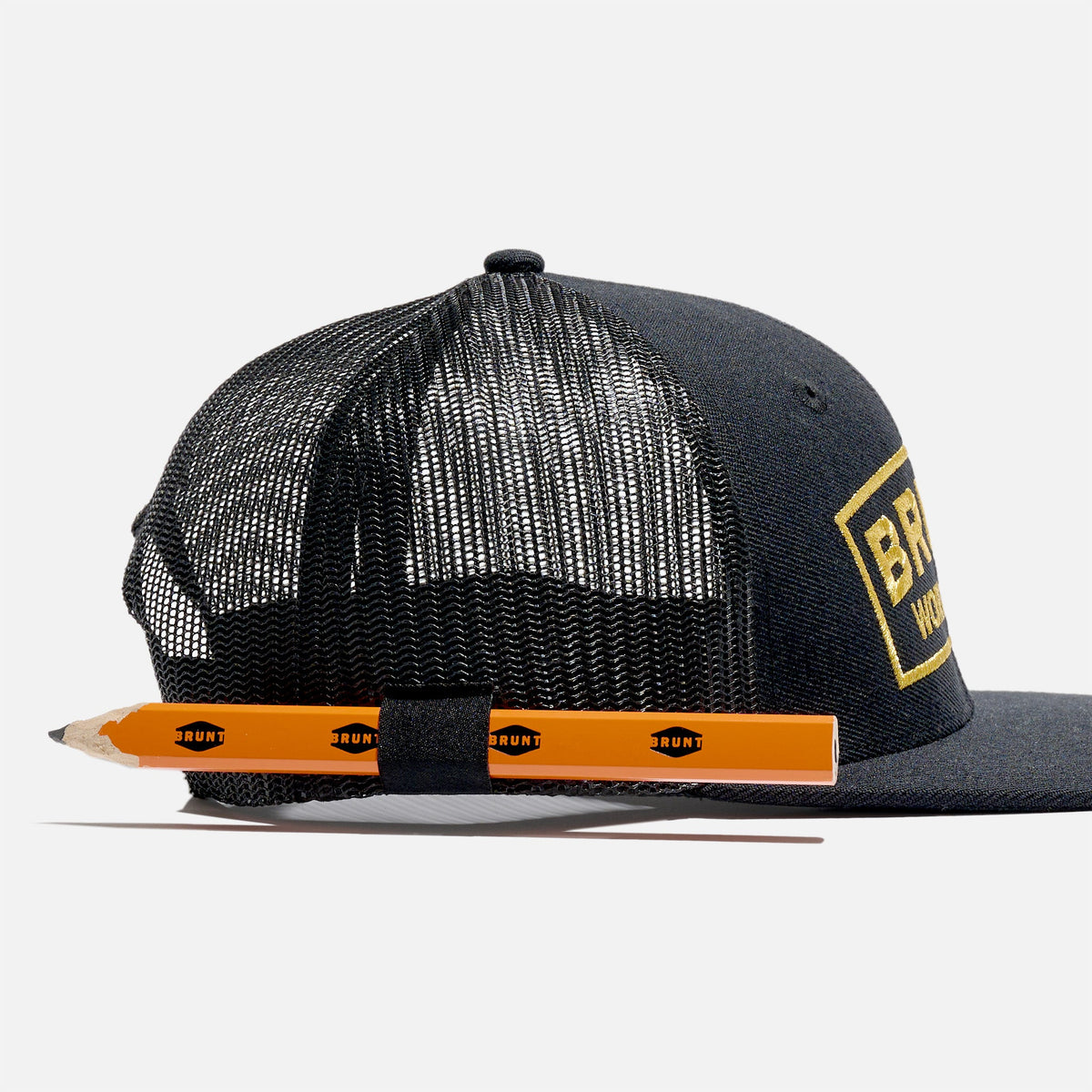 Right side of flat brim work hat with built in pencil holder and BRUNT logo in black and gold