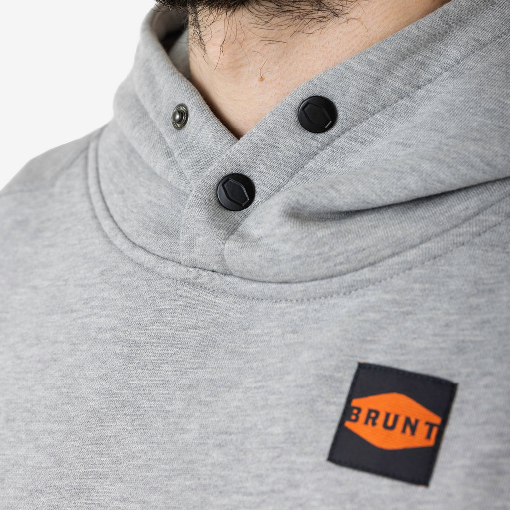 Front of button snaps of the BRUNT sleeveless water resistant workwear hoodie in light grey heather