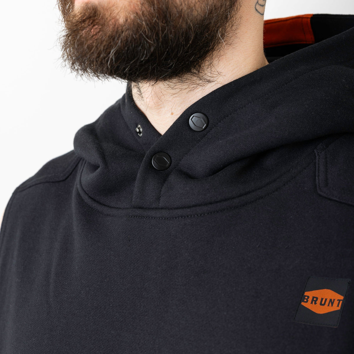 Front of button snaps of the BRUNT sleeveless water resistant workwear hoodie in black