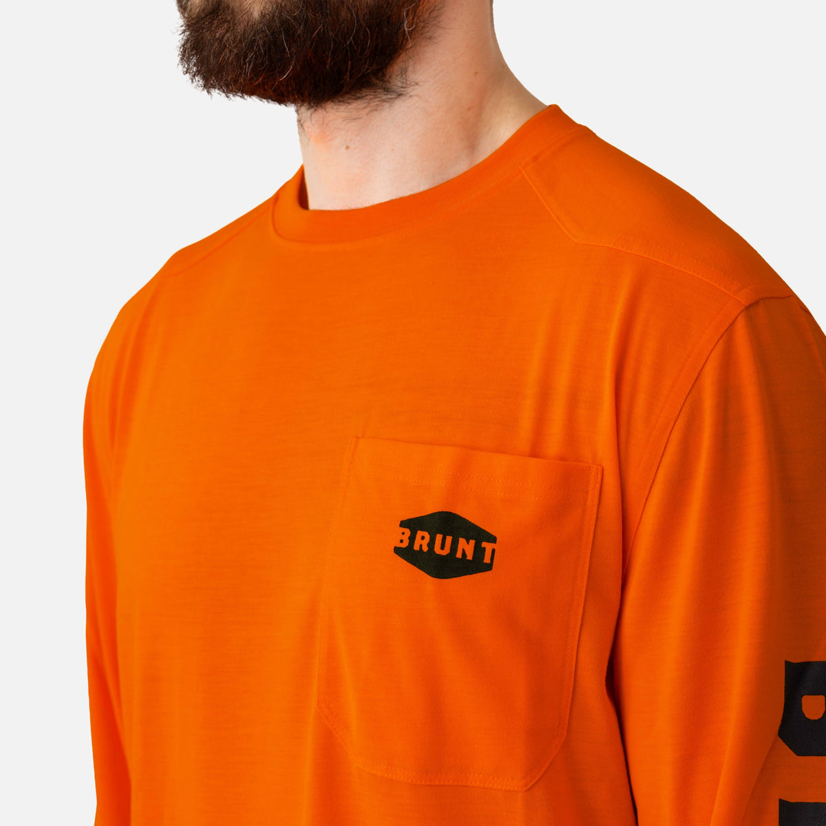 View 2 front of chest pocket with pencil slot of the BRUNT high quality long sleeve pocket tee in safety orange