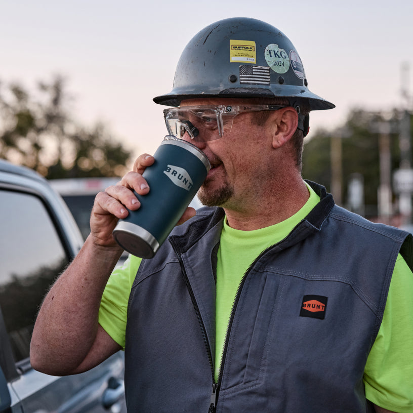 Man wearing BRUNT quilt stretch canvas work vest in charcoal on the jobsite