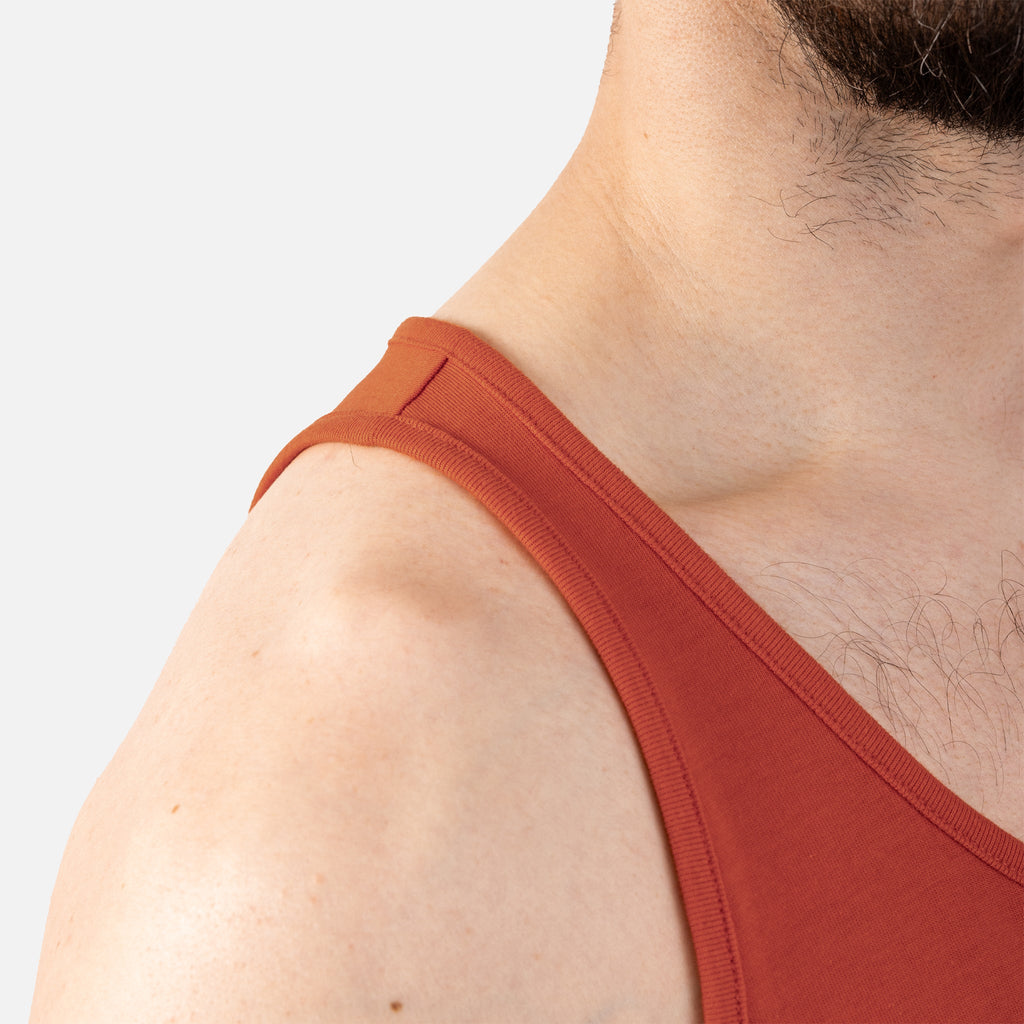 Close up of right shoulder of BRUNT comfortable work tank top in BRUNT orange