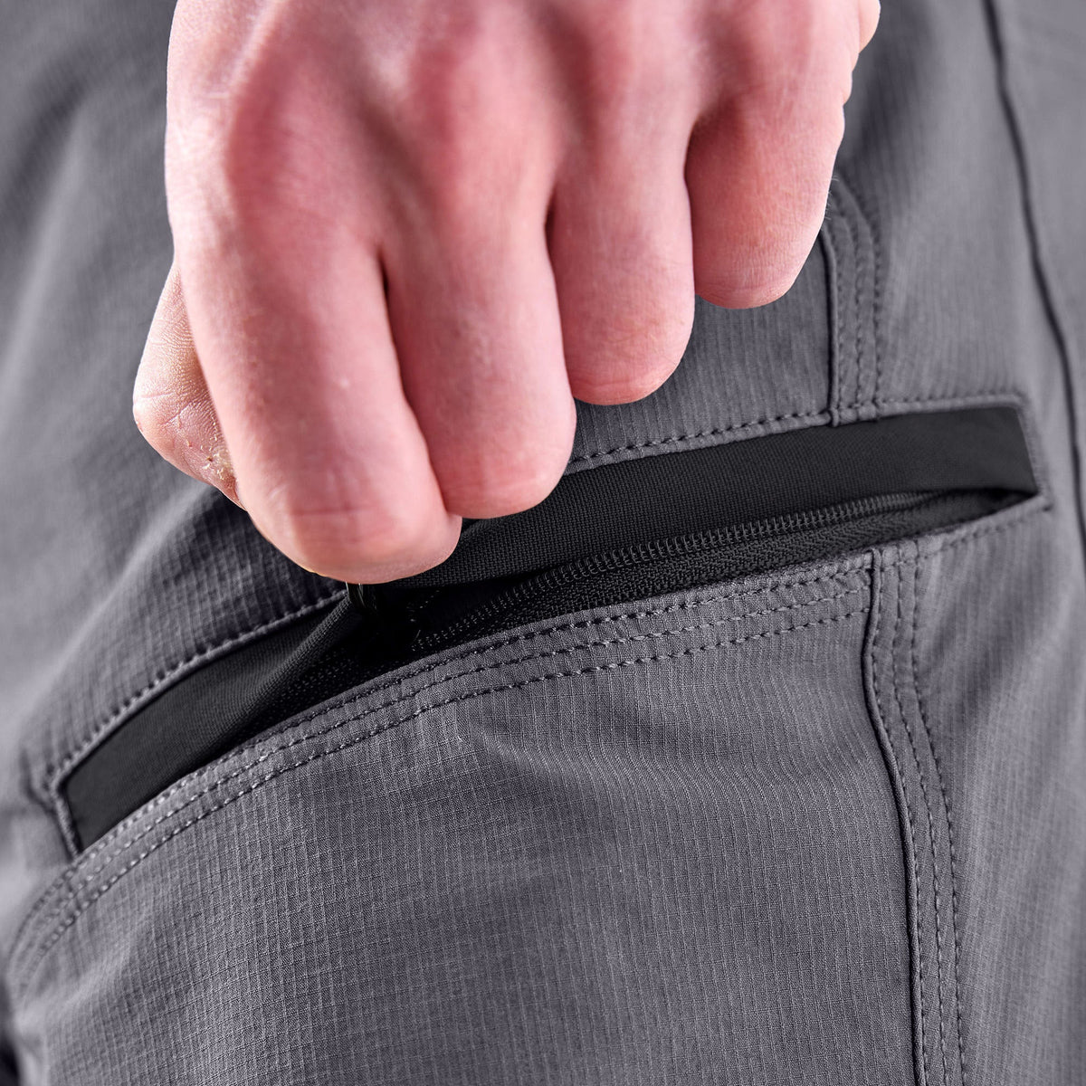 Zipper pocket of BRUNT water resistant durable breathable work pant in charcoal/black