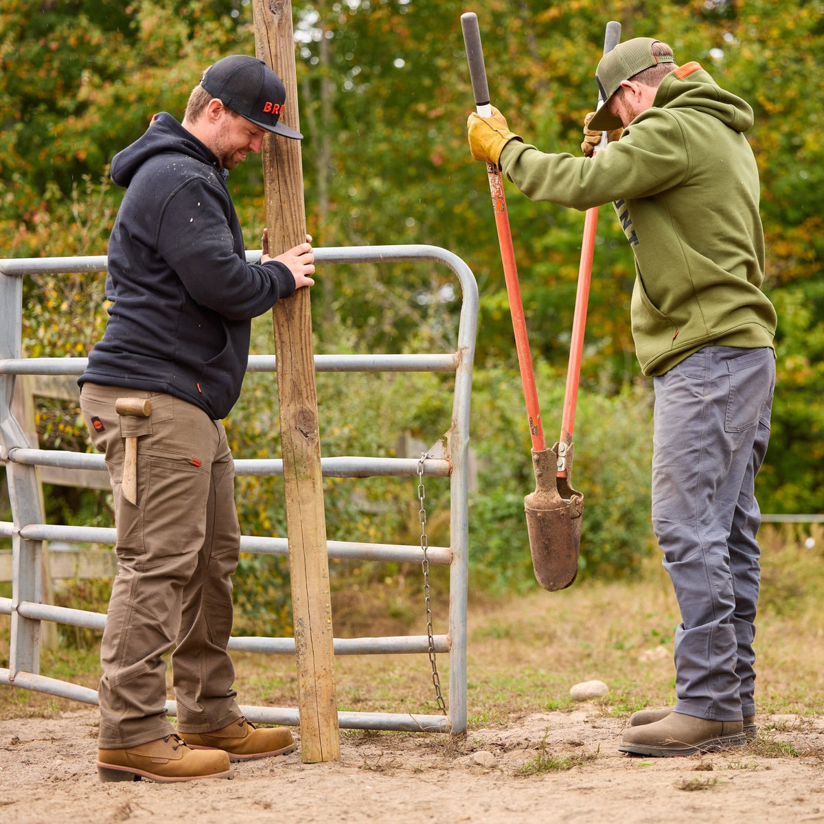 Man on jobsite wearingBRUNT water resistant double-knee torra hd utility work pant in brown with mallet in tool loop
