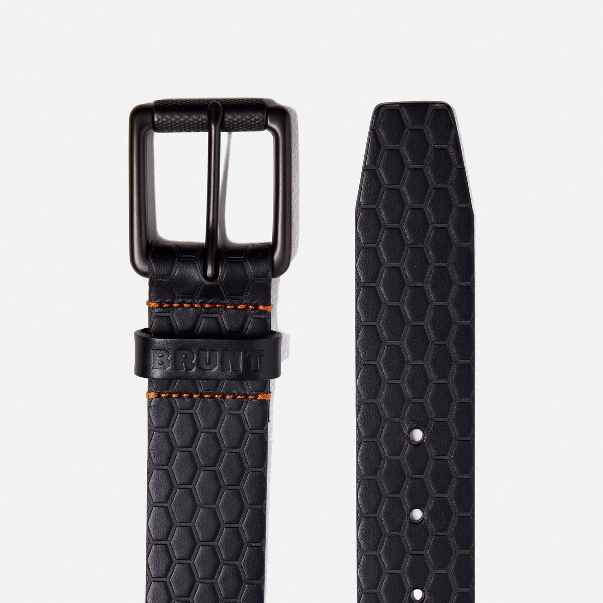 Buckle and end of BRUNT leather belt with BRUNT logo pattern in black