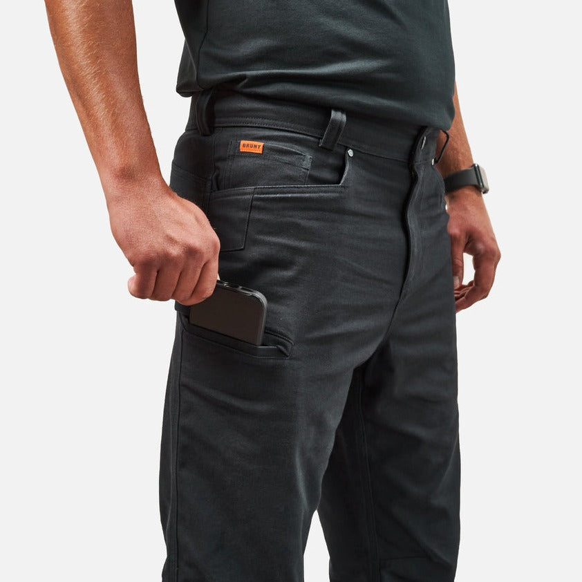 View 2 putting phone in tech pocket of BRUNT water resistant stretch torra work pant in black * 5