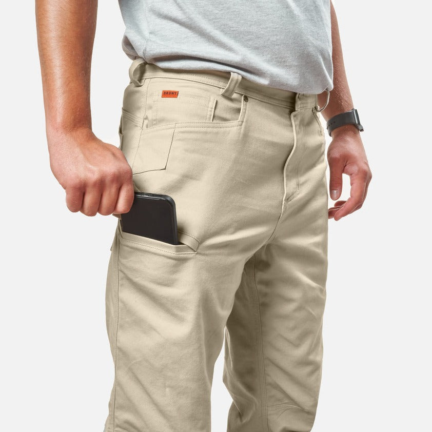 Putting phone in tech pocket of BRUNT water resistant stretch torra work pant in khaki * 2