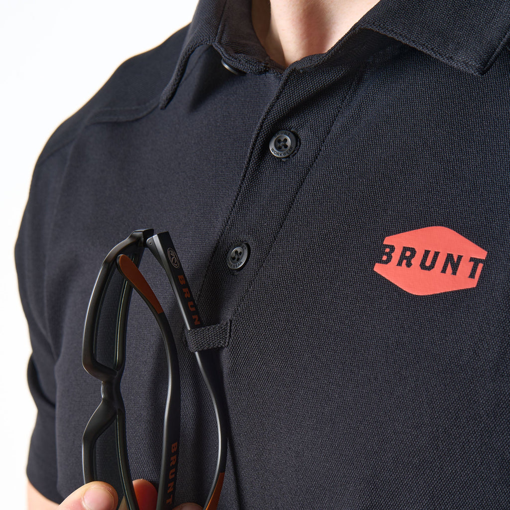 Close up of chest loop for sunglasses of the BRUNT lightweight breathable polo with UPF protection in black * 1