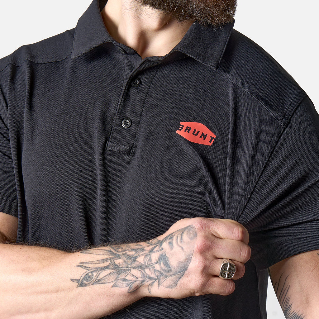 View 2 stretching front of the BRUNT lightweight breathable polo with UPF protection in black * 1