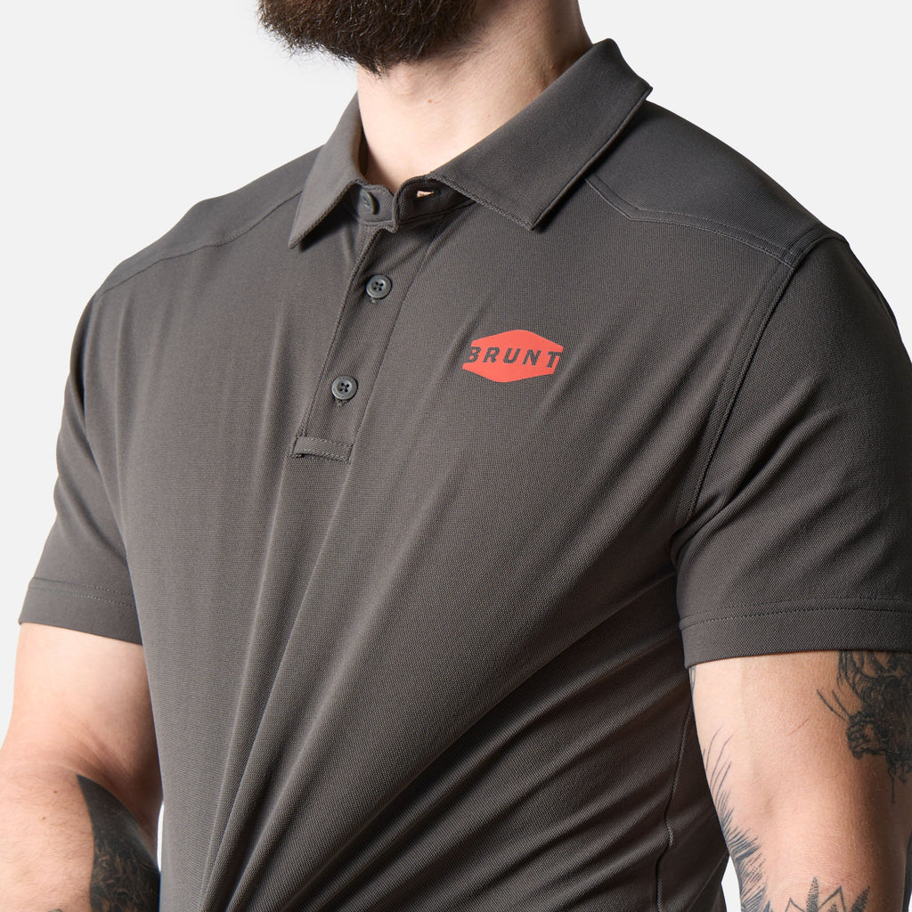 View 2 stretching front of the BRUNT lightweight breathable polo with UPF protection in carbon * 0