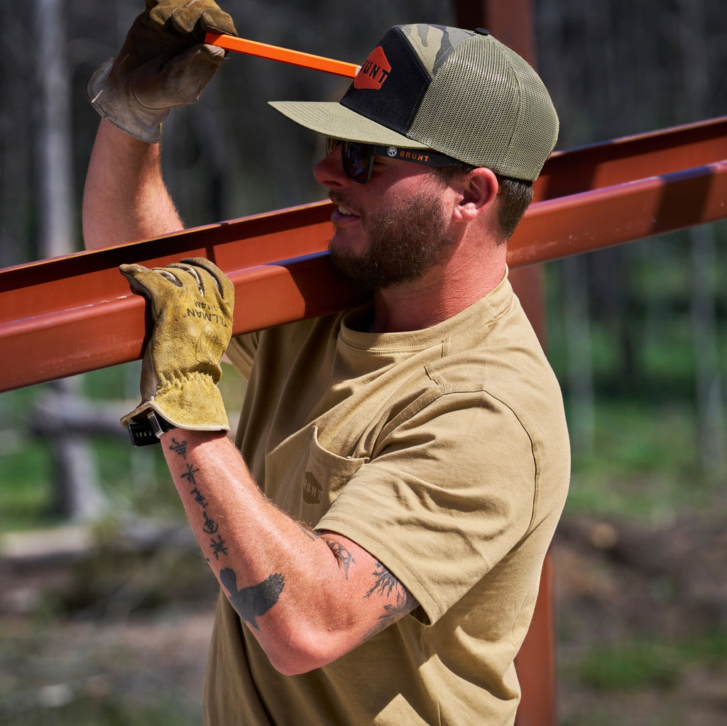 Man wearing BRUNT high quality short sleeve pocket tee in tan outside on jobsite