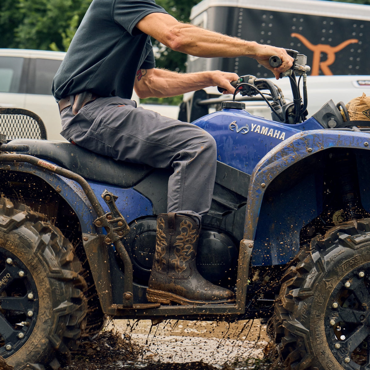 Man wearing BRUNT 10 inch welted waterproof square toe work boot in dark brown riding four wheeler