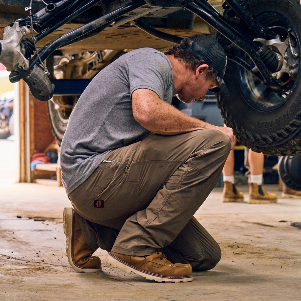 Man on jobsite wearing BRUNT 6 inch waterproof 90 degree heel marin work boot in brown