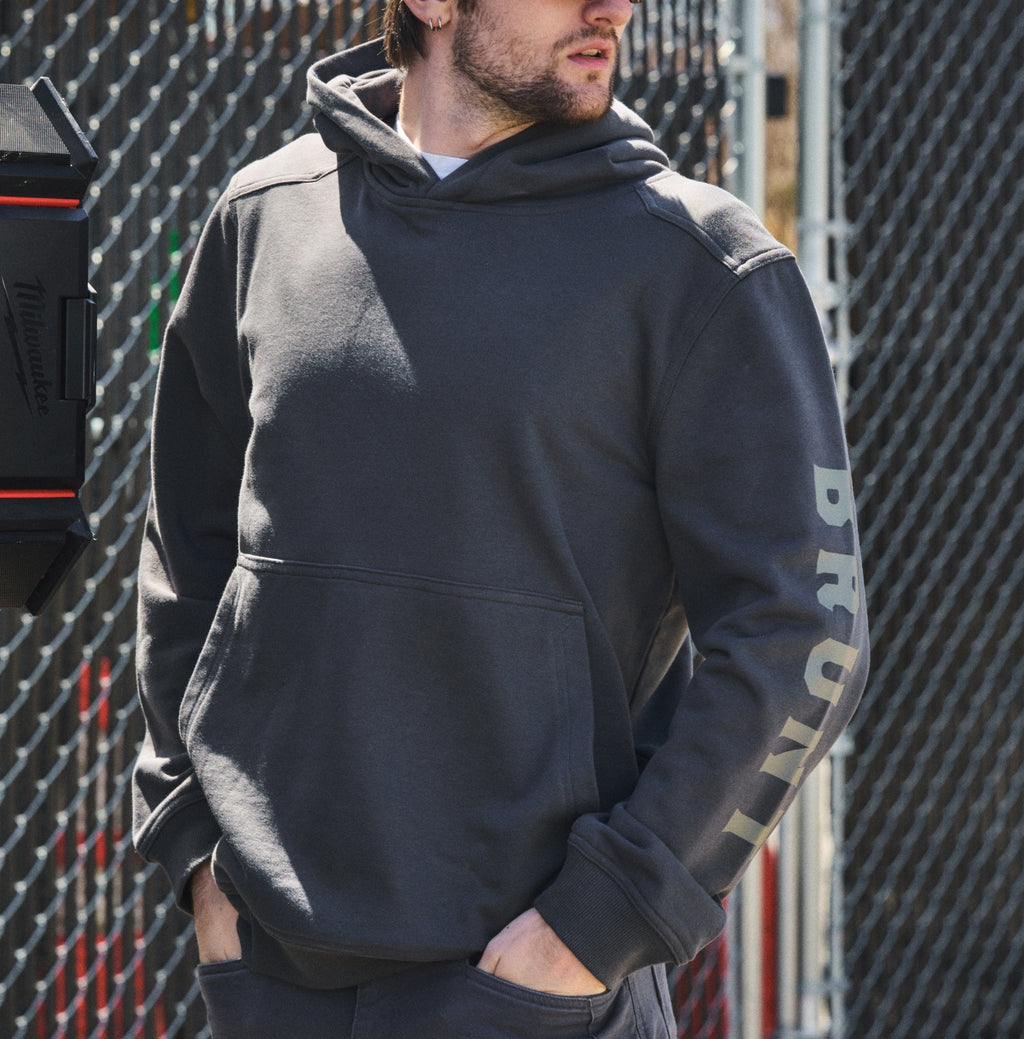 Man on the jobsite wearing the BRUNT comfortable all-season levin work hoodie in carbon