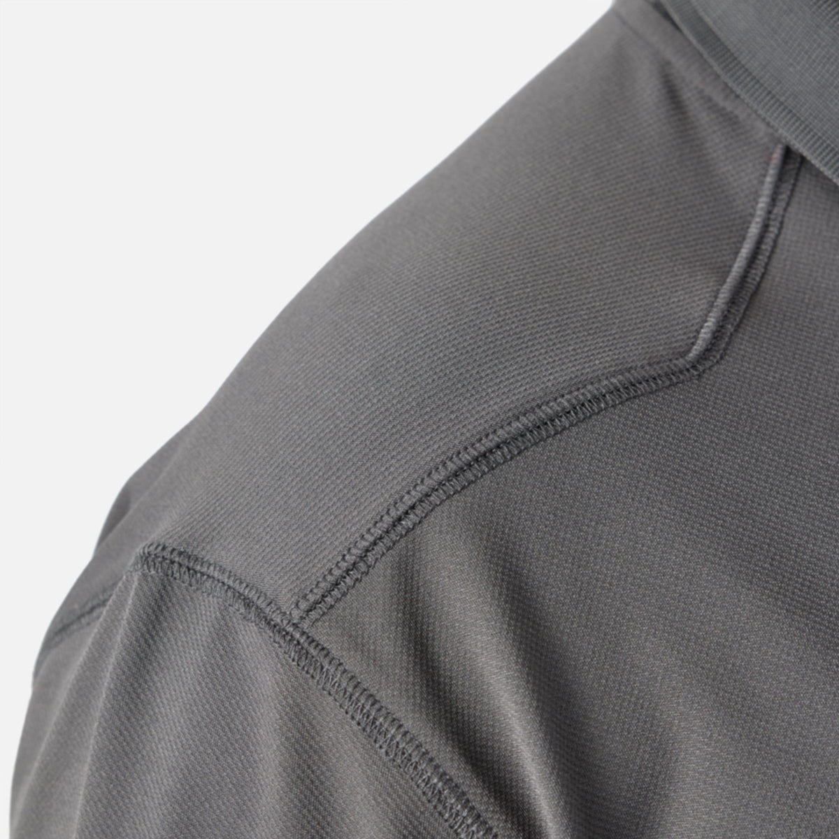 Close up of drop should seam of the BRUNT lightweight breathable ventilated tech polo with UPF protection in carbon * 1