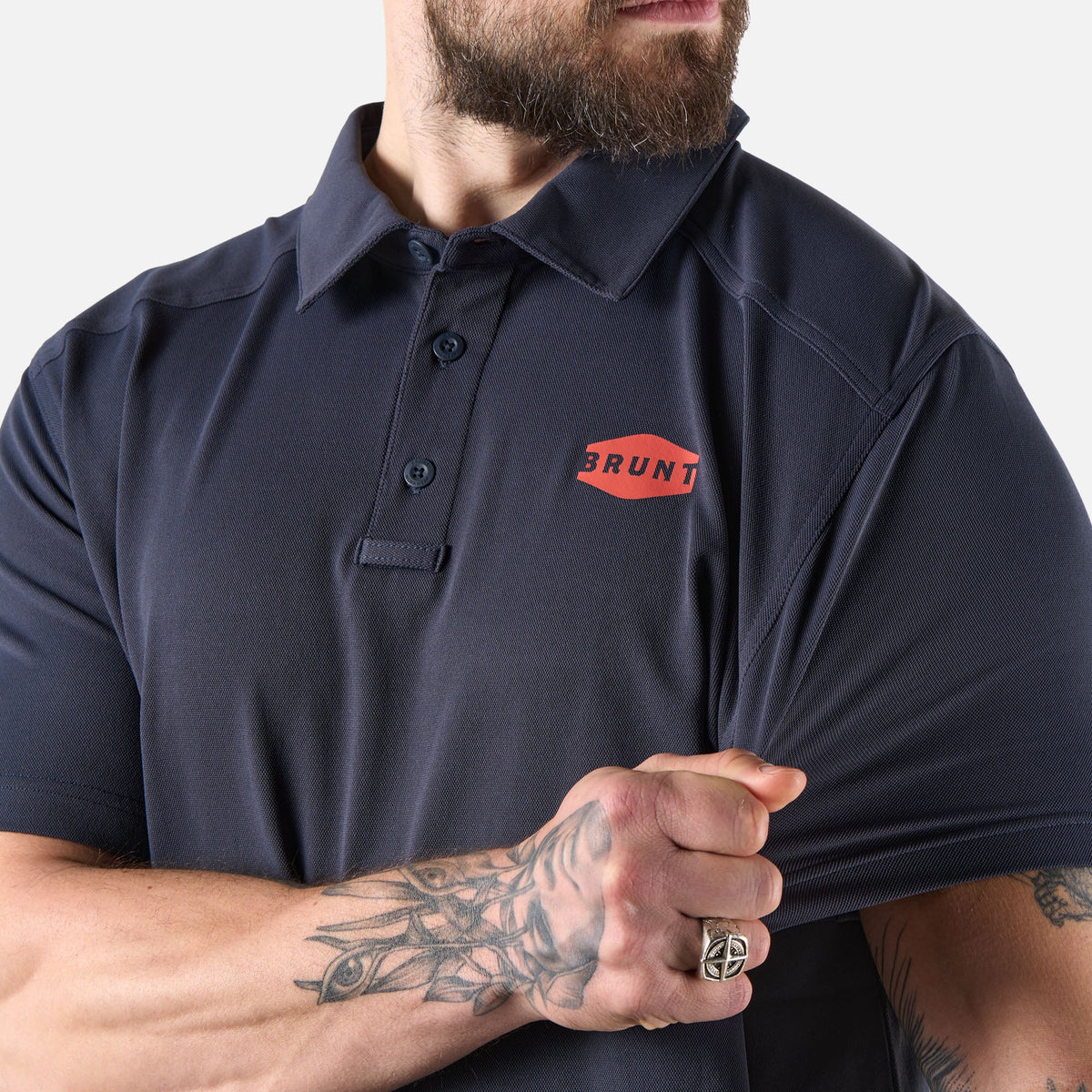 View 2 stretching front of the BRUNT lightweight breathable polo with UPF protection in navy * 3
