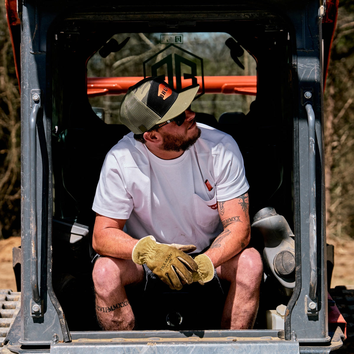 Man wearing BRUNT high quality short sleeve pocket tee in white outside on jobsite