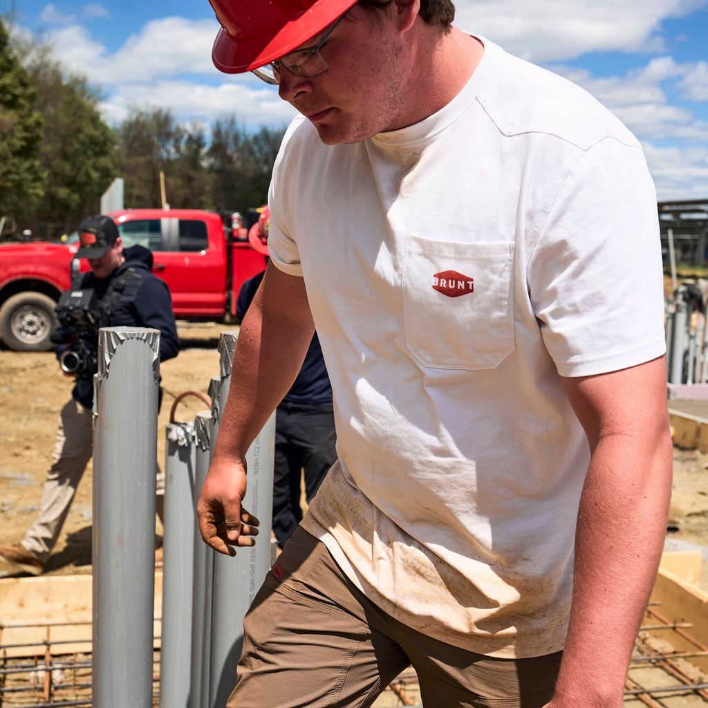 Man wearing BRUNT high quality short sleeve pocket tee in white outside on jobsite