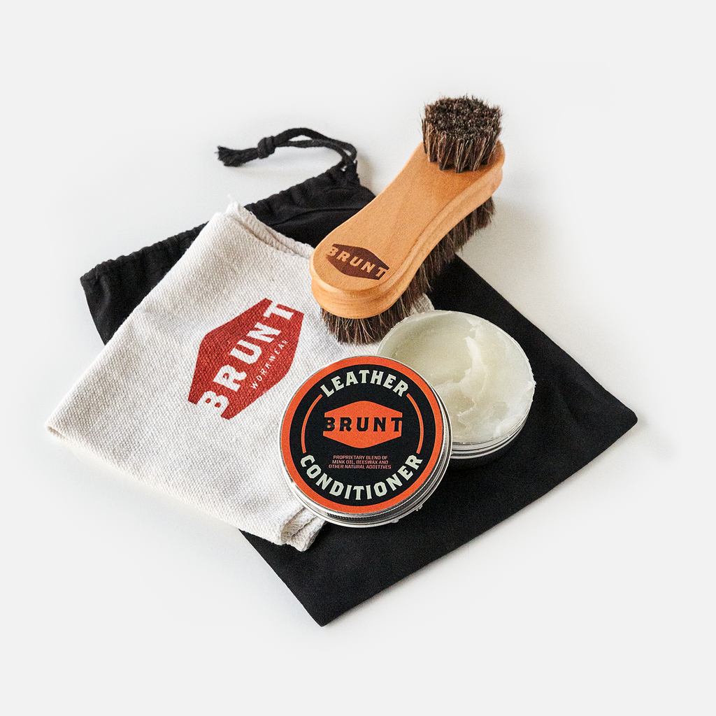 View 1 container of BRUNT leather work boot conditioner, shop rag with BRUNT logo and horse hair brush