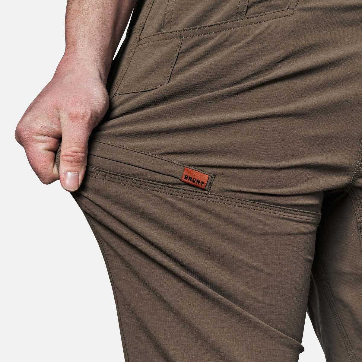 Stretching pocket of BRUNT water-resistant lightweight lined costello work pant in brown