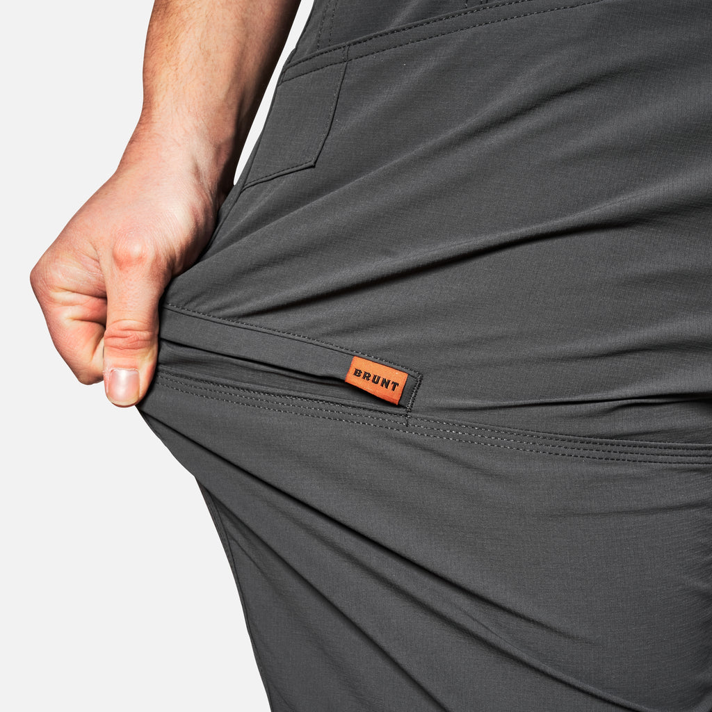 Stretching pocket of BRUNT water-resistant lightweight lined costello work pant in charcoal