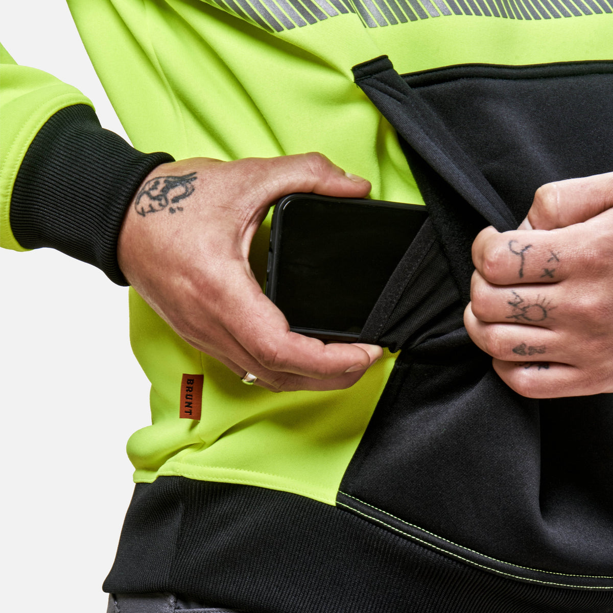 Front of hand pocket with hidden cell phone pocket of the BRUNT hi-visibilty ANSI rate shevlin hoodie