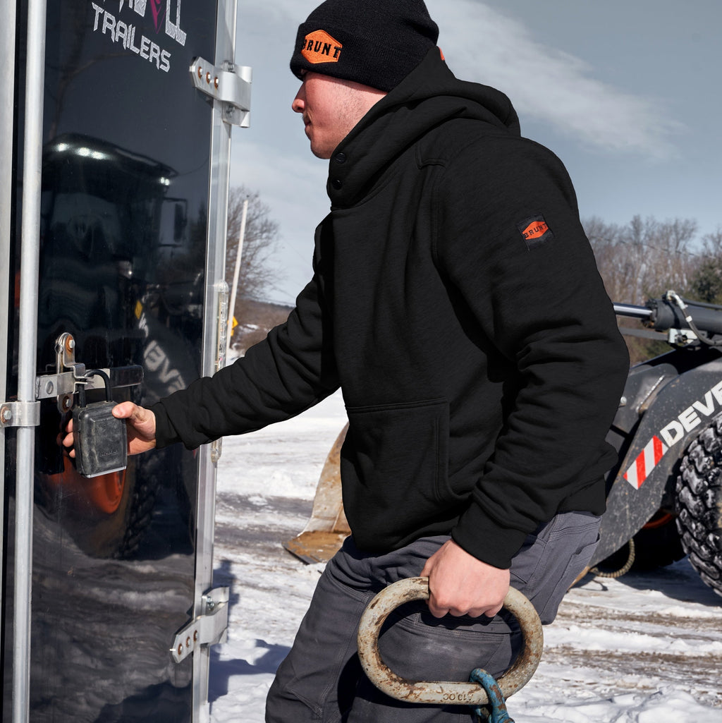 Man on jobsite wearing the BRUNT water resistant shevlin work hoodie in black