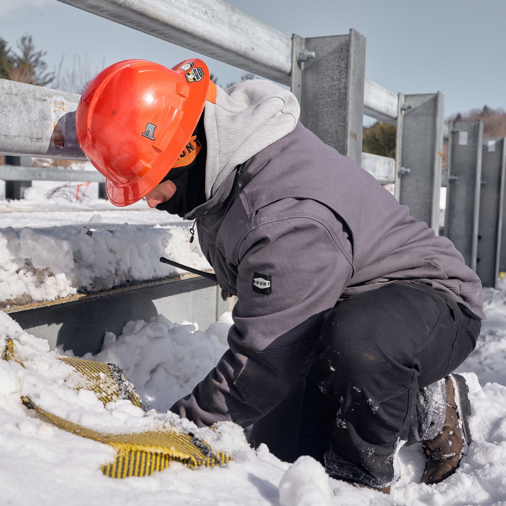 Man wearing BRUNT utility scott jacket in charcoal  on jobsite
