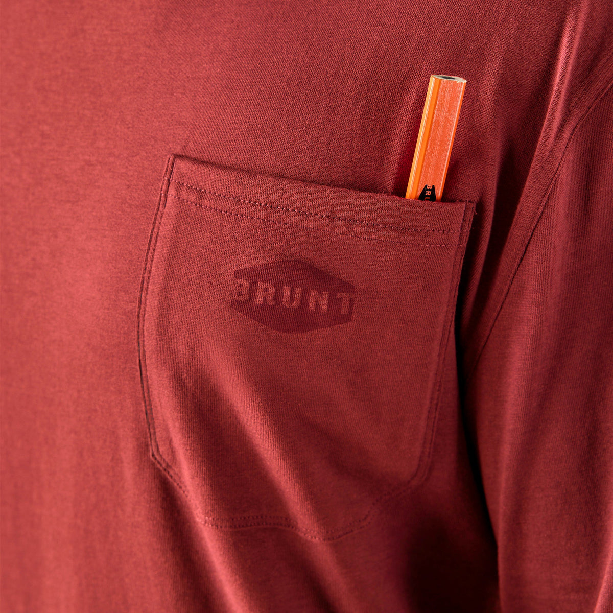 View 2 front of chest pocket with pencil slot of the BRUNT high quality long sleeve pocket tee in brick red