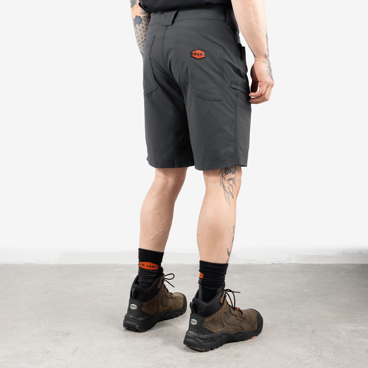 45 degree angle of back right side of BRUNT 11 inch lightweight breathable costello work shorts in charcoal