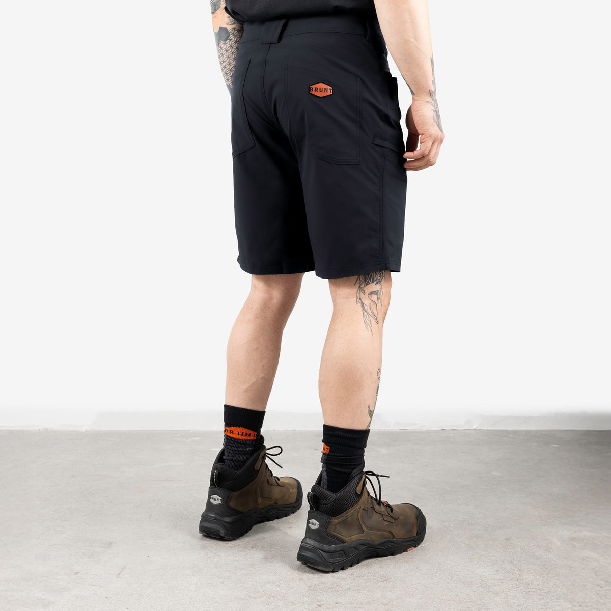 45 degree angle of back right side of BRUNT 11 inch lightweight breathable costello work shorts in black