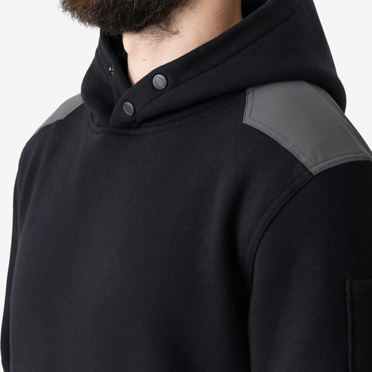 Front of button snaps of the BRUNT water resistant heavy duty shevlin work hoodie in black/charcoal