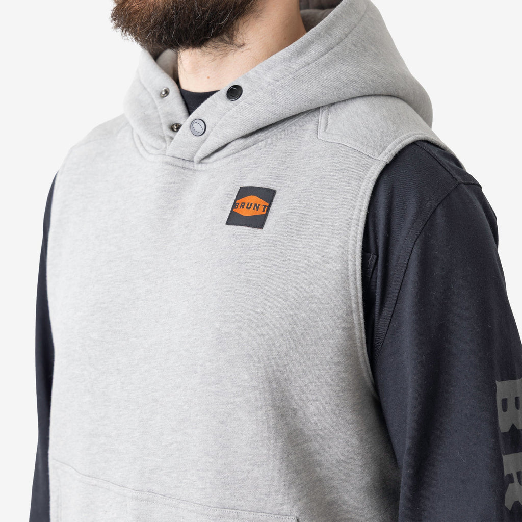 Front of button snaps of the BRUNT sleeveless water resistant workwear hoodie in light grey heather with BRUNT high quality long sleeve pocket tee in black underneath