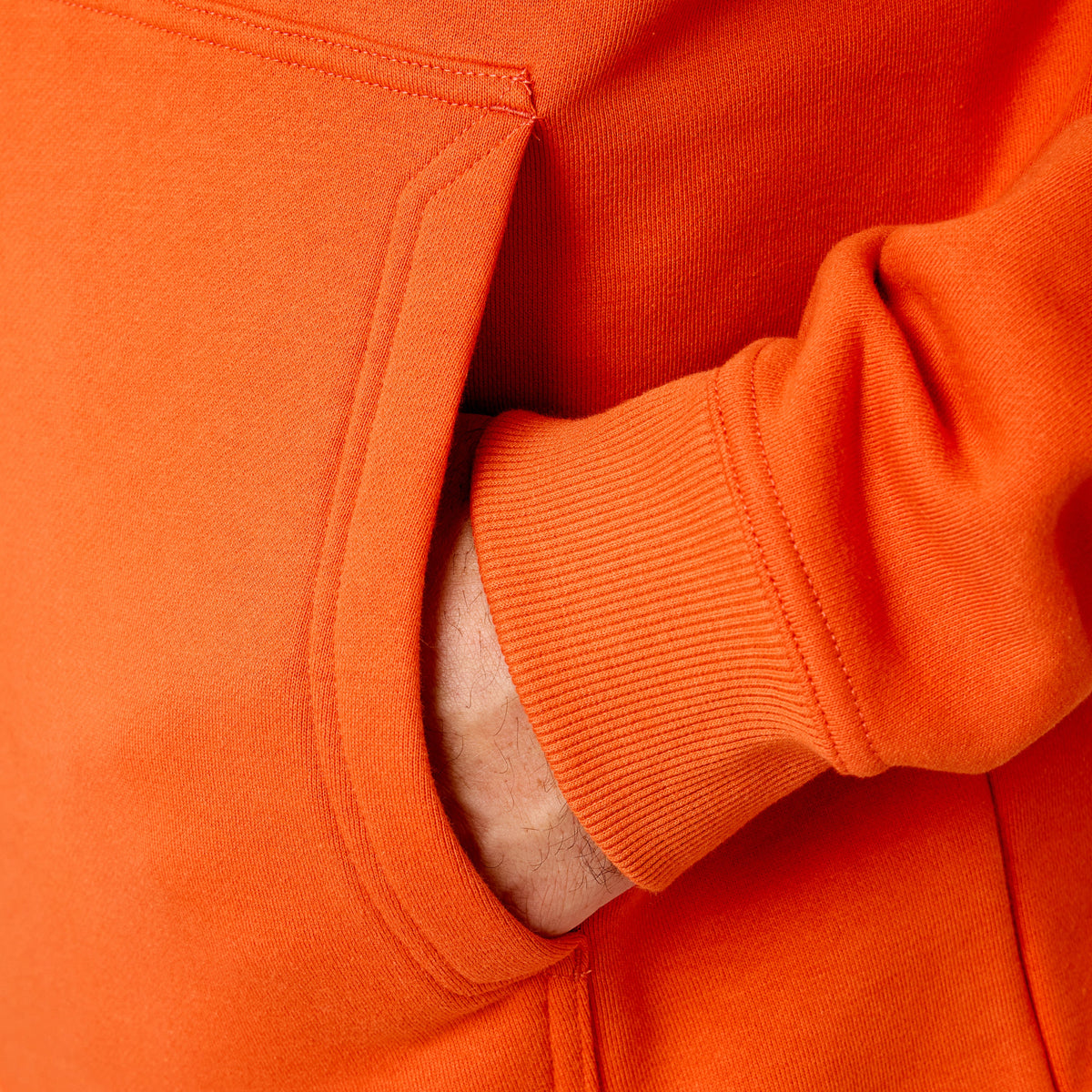Front of hand pocket of the BRUNT water resistant shevlin work hoodie in BRUNT orange