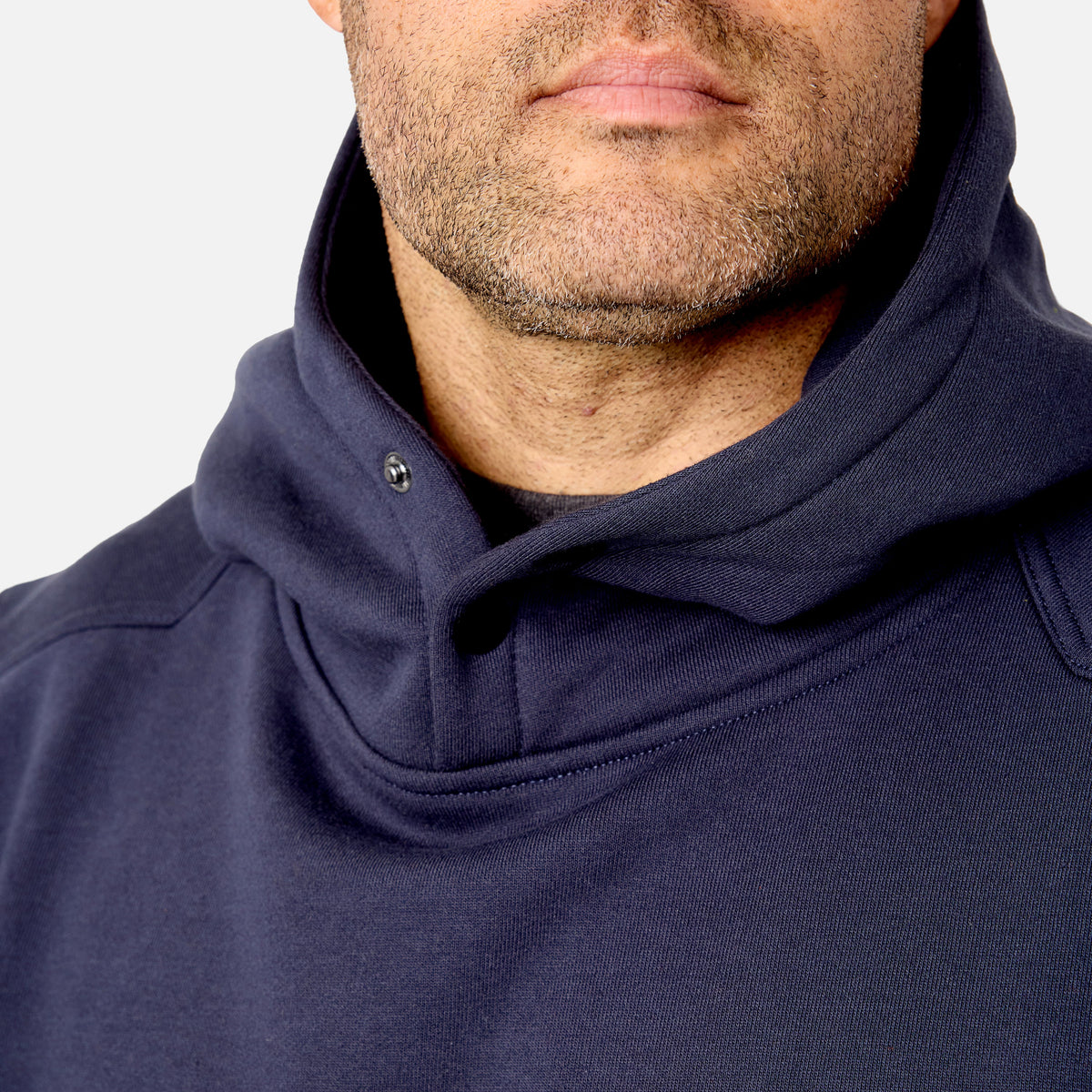 View 2 front of button snaps of the limited edition BRUNT water resistant shevlin work hoodie in navy with BRUNT on chest * 1