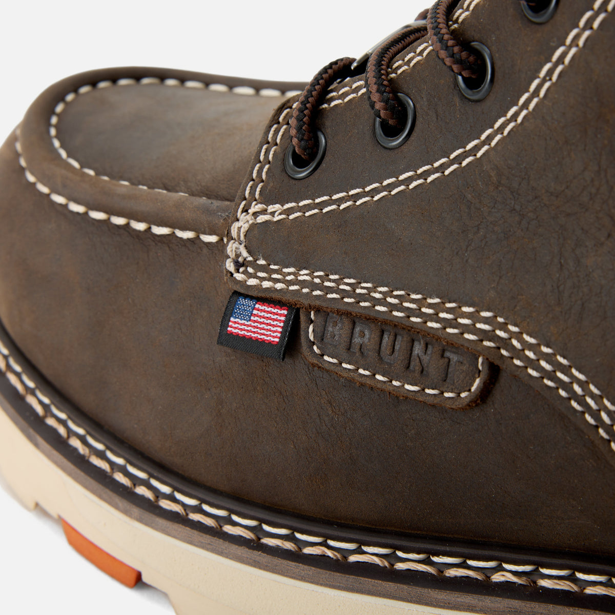 Detail shot of American flag tag and BRUNT logo tag of the BRUNT USA 6 inch waterproof welted moc toe marin work boot in dark brown