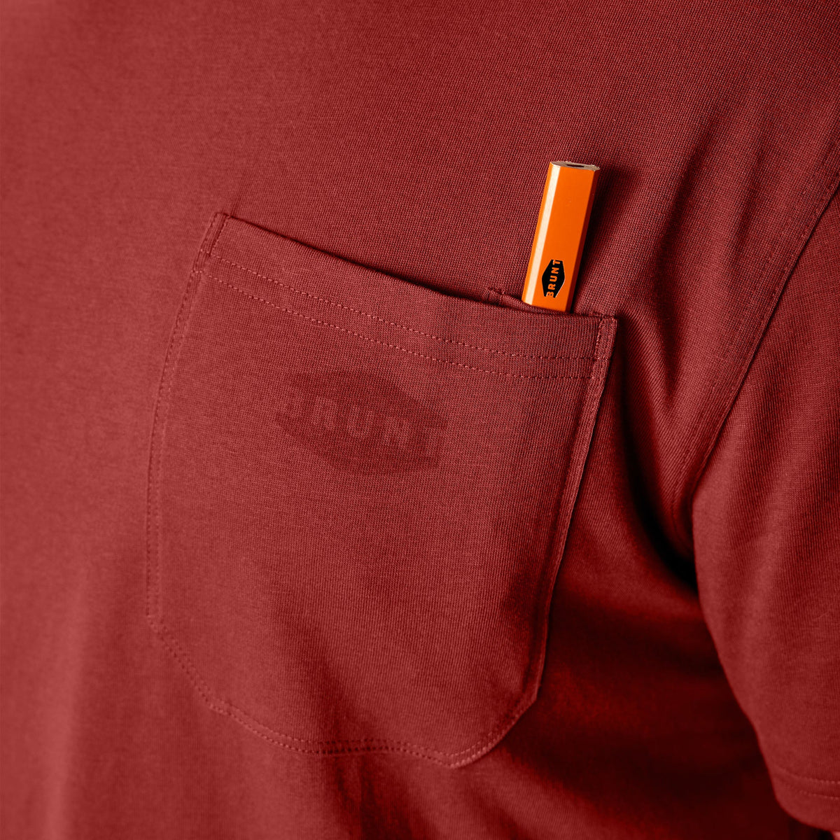Front of chest pocket with pencil slot of the BRUNT high quality short sleeve pocket tee in brick red