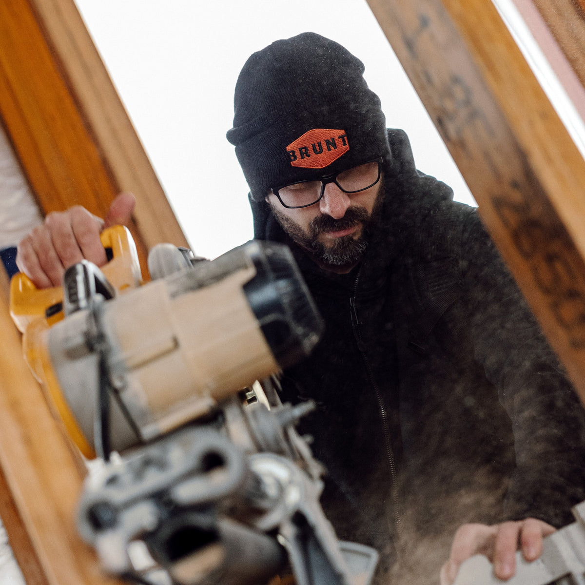 Man wearing high quality cuffed beanie in black and orange on jobsite * 2
