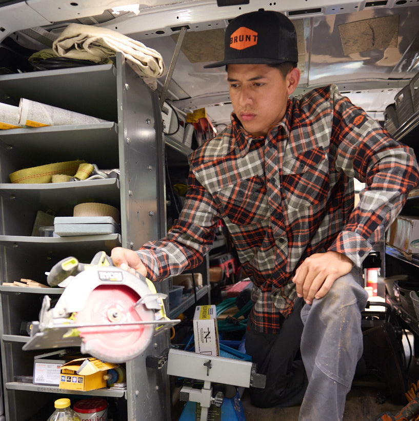 Man in BRUNT heavy duty stretch work flannel in grey plaid holding circular saw at jobsite * 2