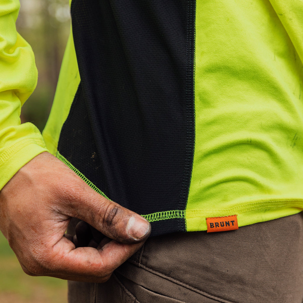 Stretching hemline of the BRUNT lightweight mckenna long sleeve sun tee with UPF protection in hi vis yellow * 1