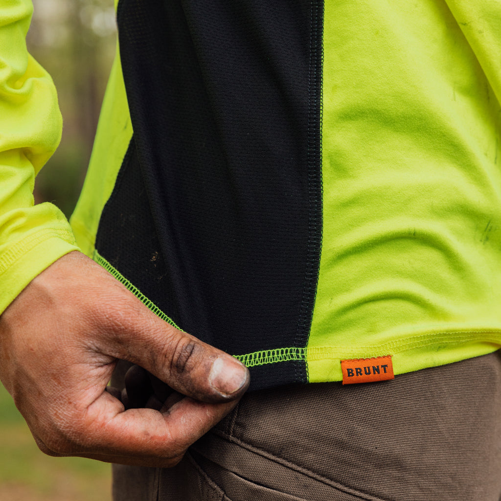 Stretching hemline of the BRUNT lightweight mckenna long sleeve sun tee with UPF protection in hi vis yellow * 2