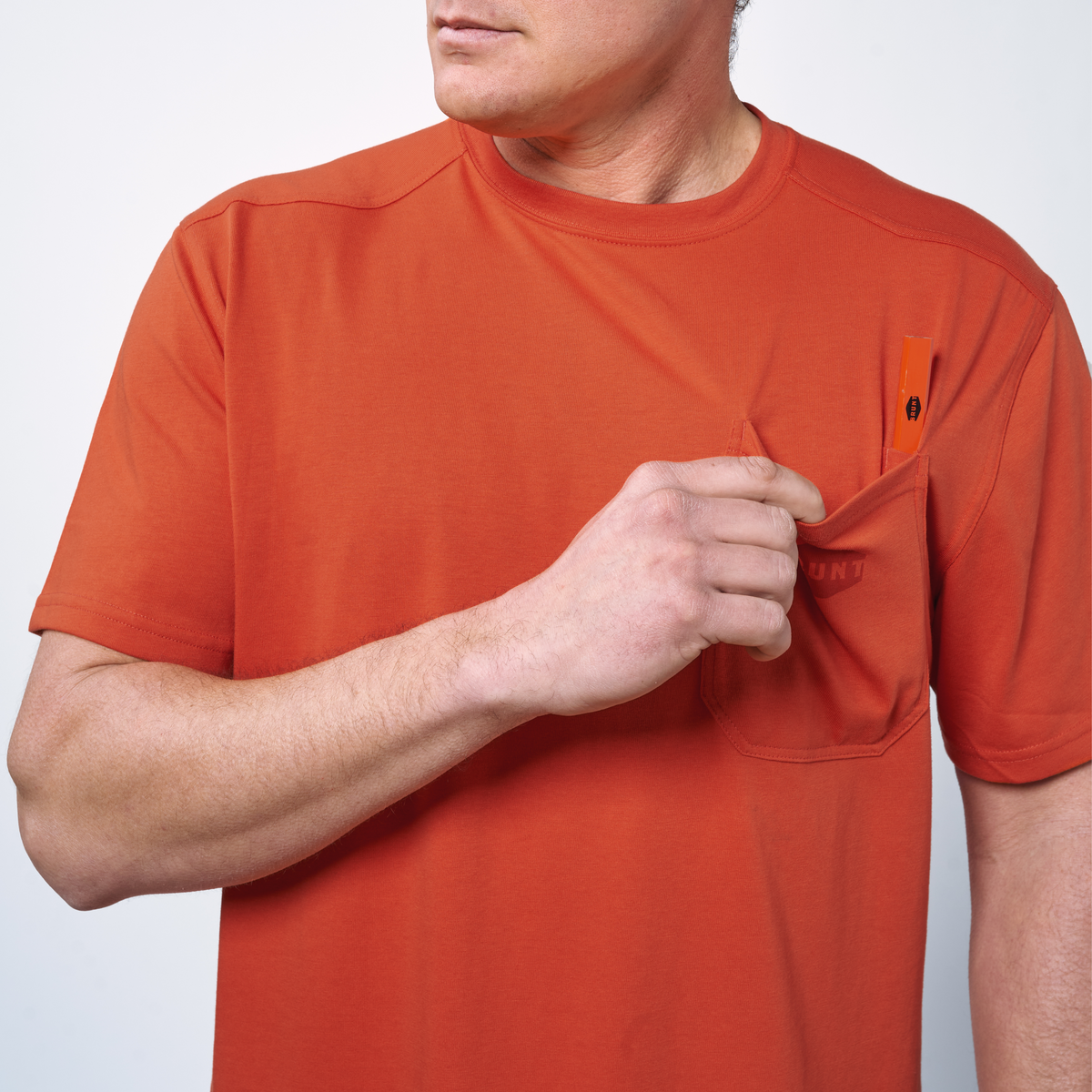Front of chest pocket with pencil slot of the BRUNT high quality short sleeve pocket tee in brunt orange